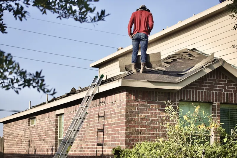 Professional roofer working on a residential roof in Del Mar Woods